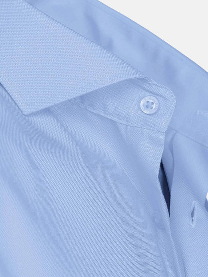 Close-up of blue dress shirt collar and textured fabric detail.