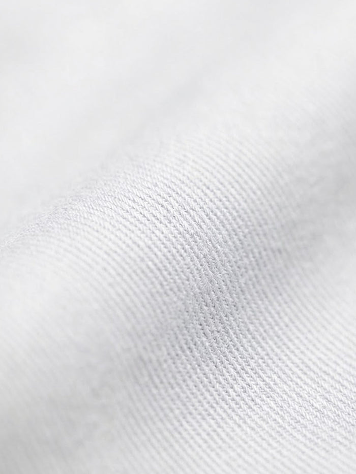 Close-up of white cotton fabric texture from men’s dress shirt
