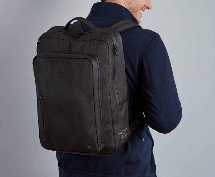 Back view of a man wearing Ion Convertible Backpack in Black Sky