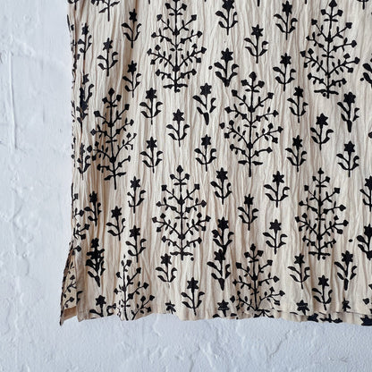 Fabric with black floral pattern on a beige background
