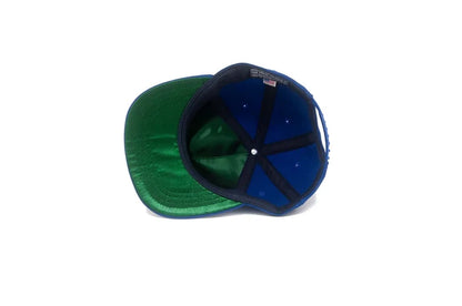 Interior view of the LA City III Series Stadium Snapback in Blue, showing the green satin underbrim and blue crown lining with The Ampal Creative label.