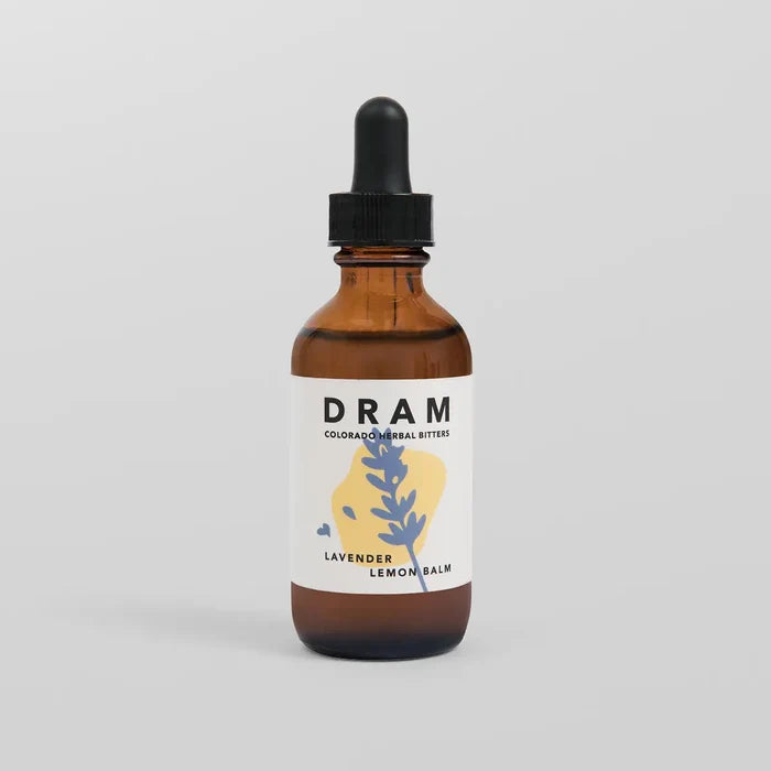 DRAM Colorado Herbal Bitters Lavender Lemon Balm Bitters 2 oz amber glass dropper bottle with illustrated label featuring a periwinkle blue lavender sprig on a soft yellow wash, against a light grey background