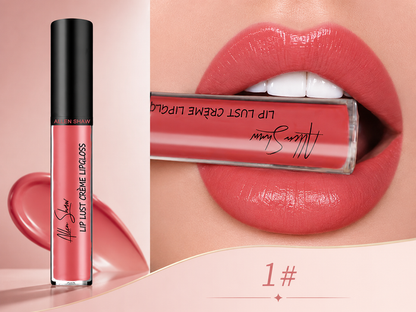 A close-up beauty listing showing an Alton Bahmy liquid lip gloss tube beside a model's lips wearing the shade. The lip gloss is a warm coral pink, labeled 'Lip Lust Crème Lipgloss' with the Alton Bahmy signature on the tube.