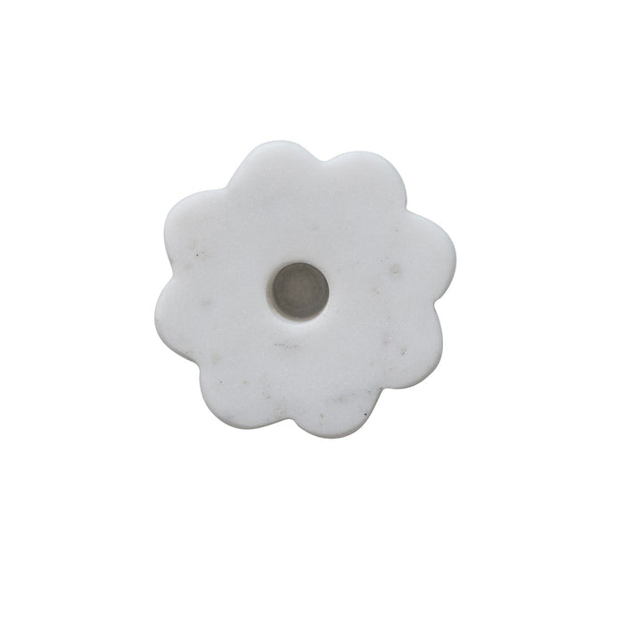 White marble flower-shaped candle holder on a white background