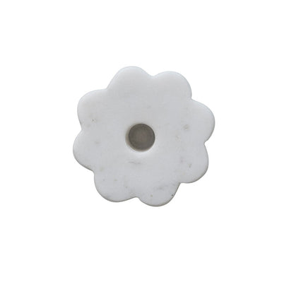 White marble flower-shaped candle holder on a white background