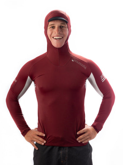 Smiling man wearing a maroon Waihana Carvico hooded surf rashguard with grey side panels and built-in hood, shown from the front against a white background.