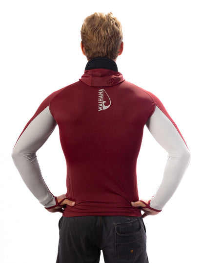 Back view of a man wearing the Waihana Maroon Carvico Hooded Surf Rashguard with grey sleeve accents and Waihana logo on the upper back, styled with dark shorts on a white background.