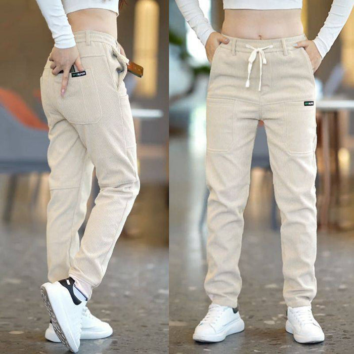 Model Striding in Beige Men's 6-Pocket Track Sweatpants – Effortless Loose Fit Captured