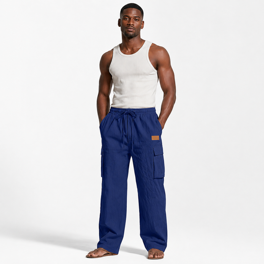 Men's cotton linen pants in navy blue shown on an adult male model in a clean full-body front studio view.