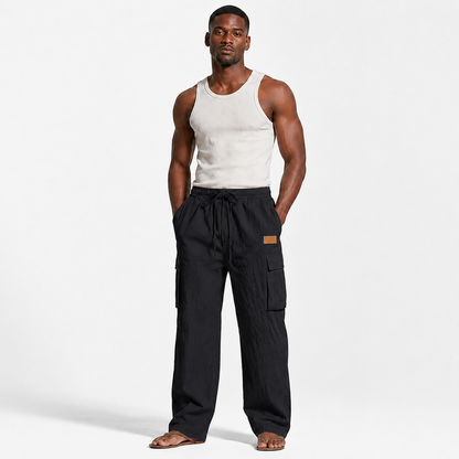 Men's cotton linen pants in black shown on an adult male model in a clean centered full-body Shopify product image.