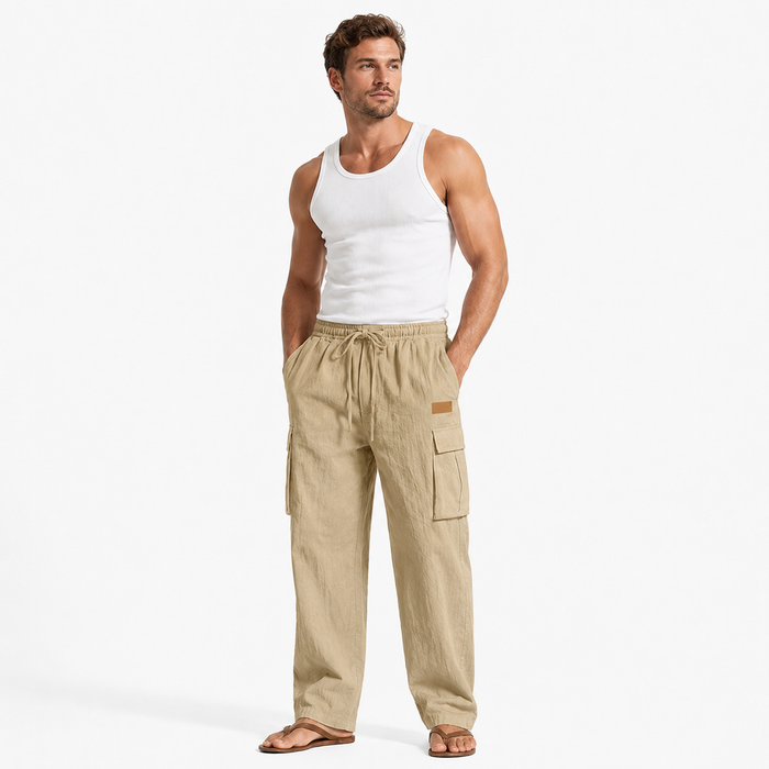 Men's cotton linen pants in khaki shown on an adult male model in a minimal studio lifestyle pose with a clean white background.