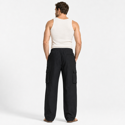 Men's cotton linen pants in black shown from the back on an adult male model against a clean white studio background.
