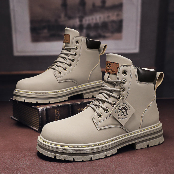 Pair of beige boots with a brand logo on a dark surface