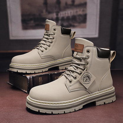 Pair of beige boots with a brand logo on a dark surface