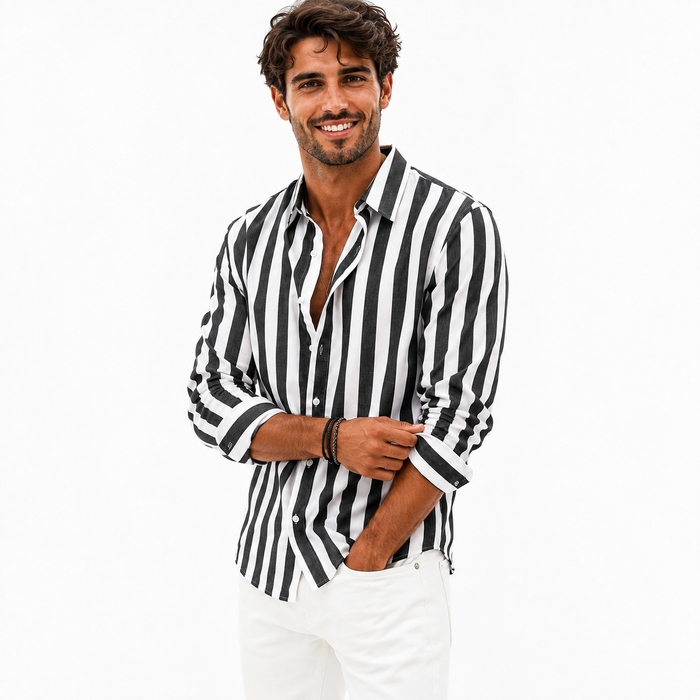 Black and white men's striped button-front shirt on a male model adjusting the cuff, photographed on a clean white background.