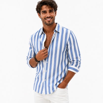 Men's blue and white striped button-front shirt on a male model touching the placket, photographed against a clean white background.