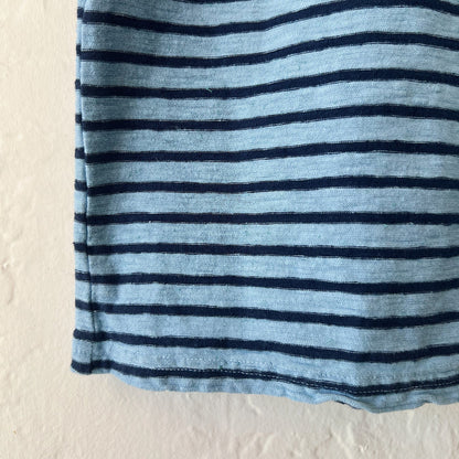 Close-up of a blue and navy striped fabric on a beige background
