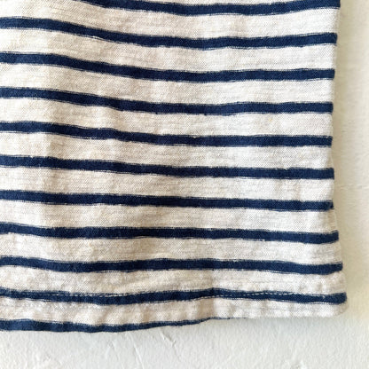 Close-up of a fabric with navy and white horizontal stripes on a white background
