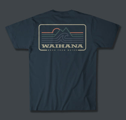 Back of the Waihana Ocean Elements Premium Pima T-Shirt in Abyss Blue, displaying a retro badge graphic with mountain peaks, ocean waves, a rising sun, and the tagline 'Born From Water'.