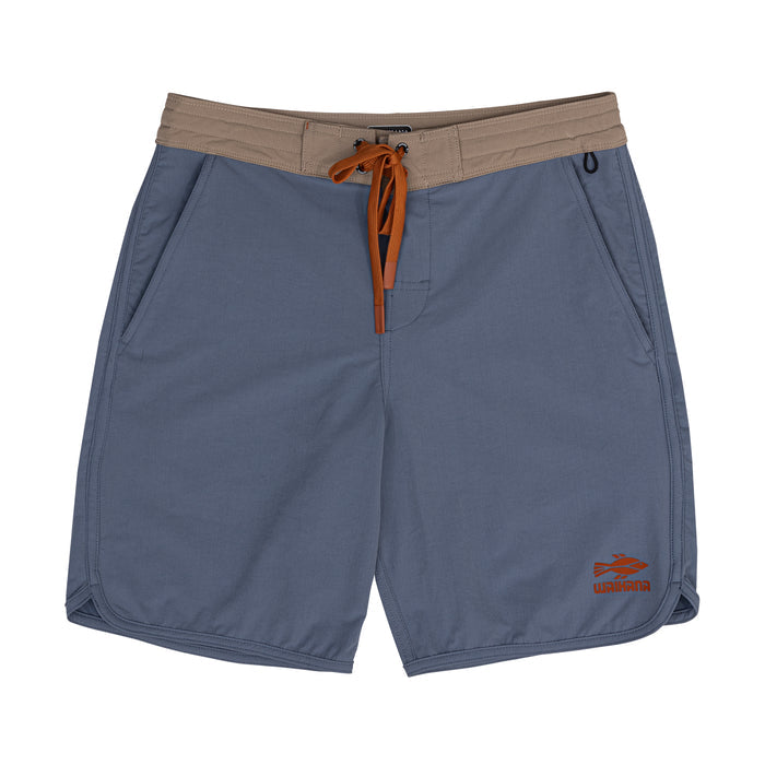 Waihana Offshore Blue Cruiser Board Shorts laid flat, featuring a slate-blue body, contrast tan waistband, orange drawstring, and embroidered Waihana fish logo on the hem.
