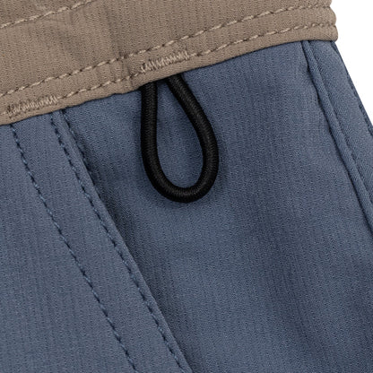 Close-up of the Waihana Offshore Blue Cruiser Shorts showing the tan quilted inner waistband, blue outer fabric, and black elastic loop closure detail.