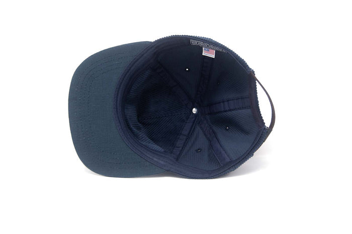 The underside view of a navy blue baseball cap on a white background