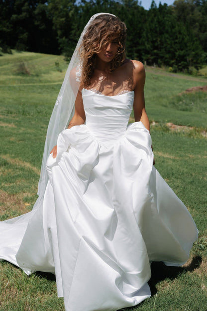 Woman in a white wedding dress with a long veil