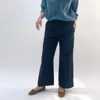 Poplin Sailor Pant in Ink — front three-quarter view with hand in pocket, highlighting wide-leg fit and drawstring waistband