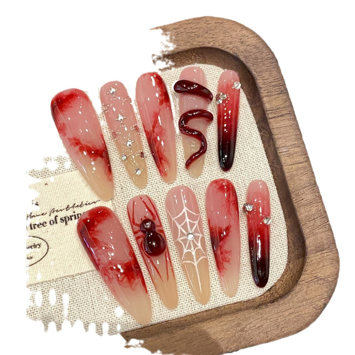 Chinese-style red press-on nails with checkerboard, heart and leopard motifs presented for bold everyday or event nail looks.
