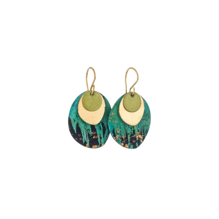 Pair of Sibilia Rock Earrings in Forest, featuring a small matte gold crescent-shaped disc layered over a large oval treated brass drop with a dramatic forest green, teal, black, and gold speckle oxide patina finish, on gold wire hooks, on a white background