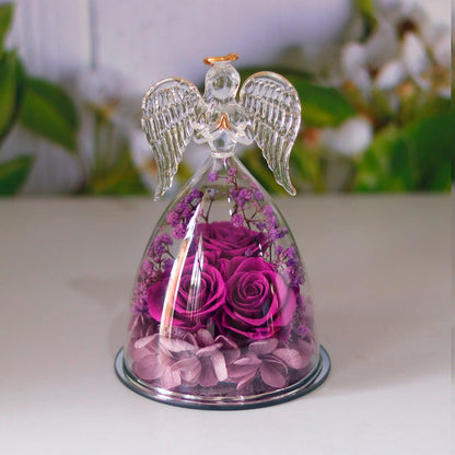 Close-up of the rose arrangement in the angel glass display showing visible form and layered decorative presentation clearly.