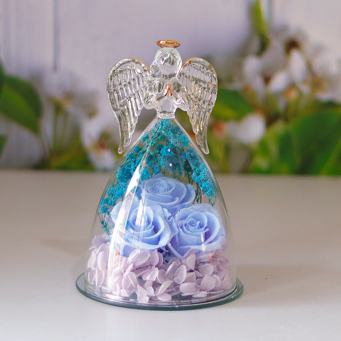 Glass angel figurine with rose arrangement presented for a shelf or desk, with the decorative structure clearly viewed today.