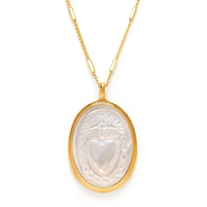 Gold necklace with a heart-shaped pendant on a white background
