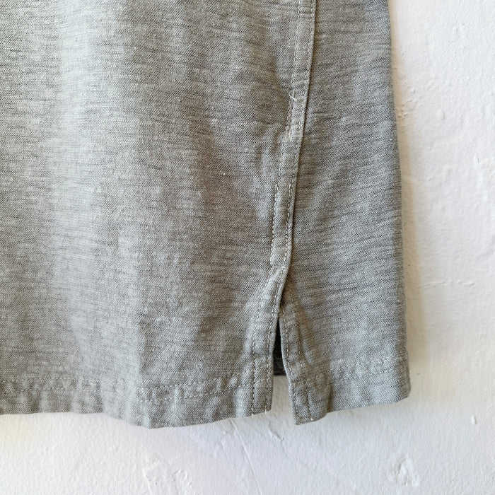Close-up of green fabric with a visible seam on a white background