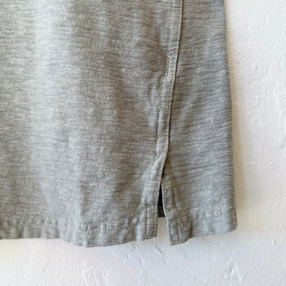 Close-up of green fabric with a visible seam on a white background