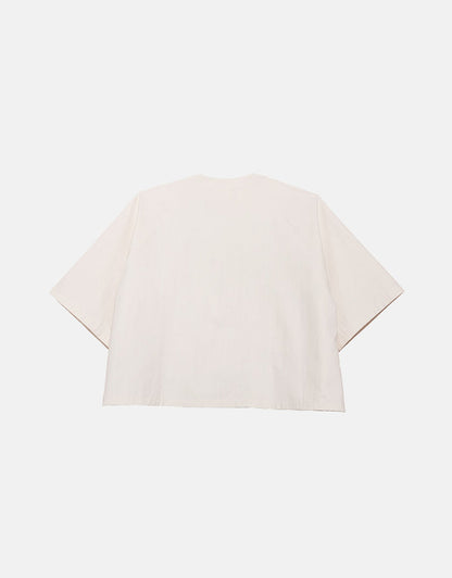 Off-white minimalist short sleeve shirt with a boxy silhouette, designed for unisex wear, emphasizing clean lines and subtle volume for ease of movement.