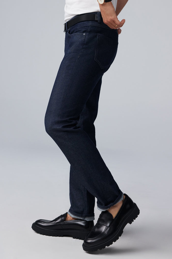 Side view of man wearing SILVER Denim in Dark Indigo Rinse