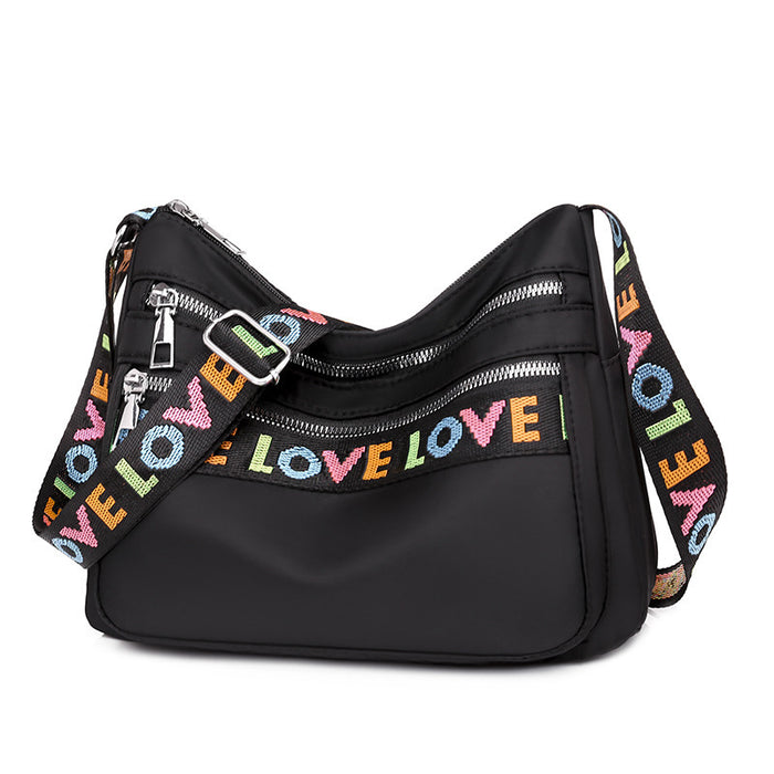 Timeless Black Oxford Cloth Crossbody Bag with Soft Fabric and Letter Embellishments