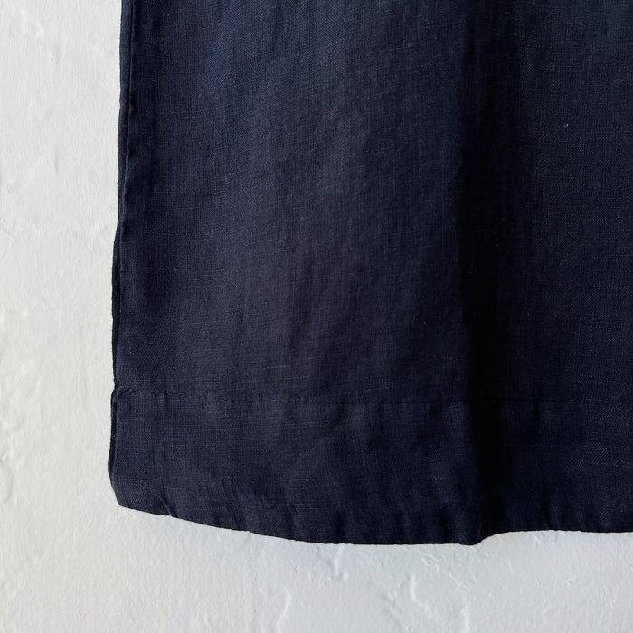 Close-up of black fabric against a textured white background