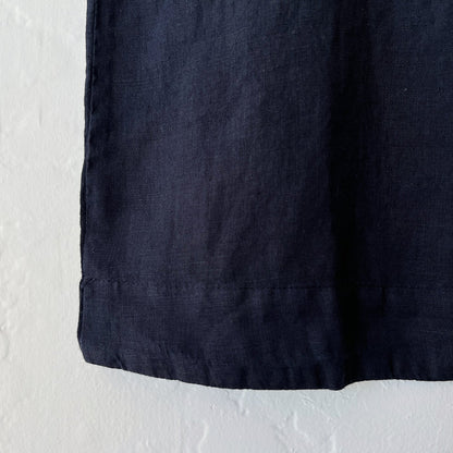 Close-up of black fabric against a textured white background
