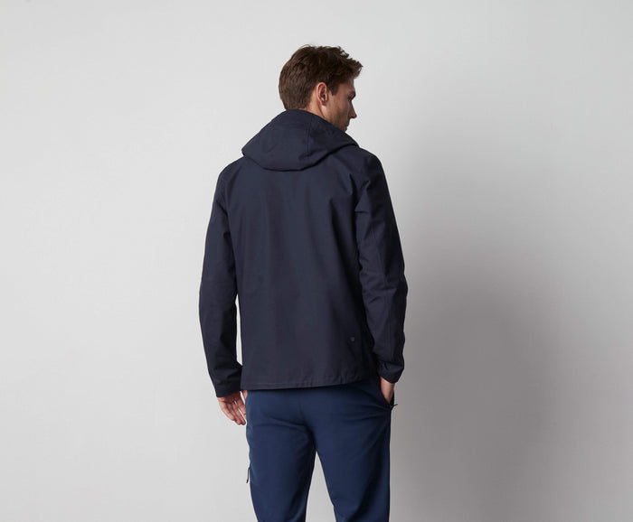 Back view of a man wearing Stormchaser Jacket in Total Eclipse