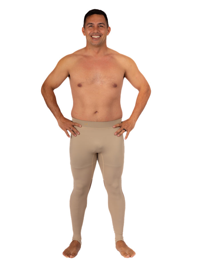 Shirtless male model wearing Waihana Tan Carvico Lycra rashguard leggings, standing with hands on hips against a white background.