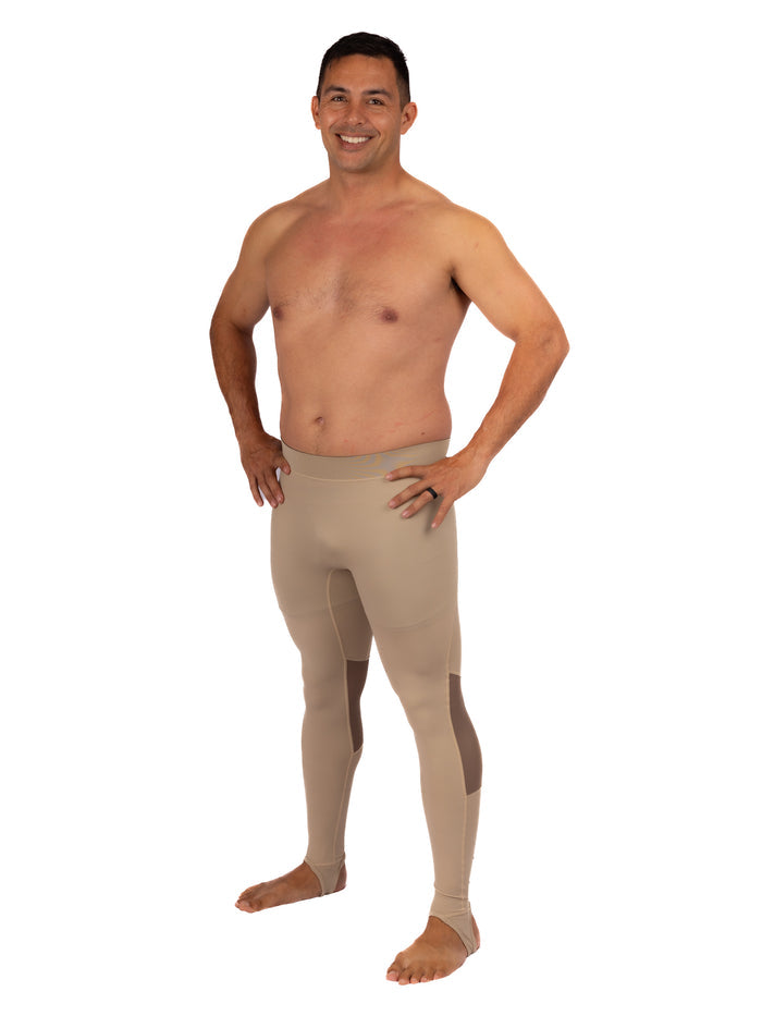 Shirtless male model wearing Waihana Tan Carvico Lycra spearfishing leggings with reinforced knee panels and ankle stirrups, shown from the front on a white studio background.