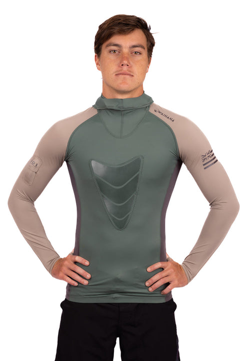 Male model wearing the Waihana Terra Hooded Spearfishing Rashguard in olive green and sand tan colorway, featuring a chest loading pad, mock neck hood, and Hawaiian flag sleeve logo.