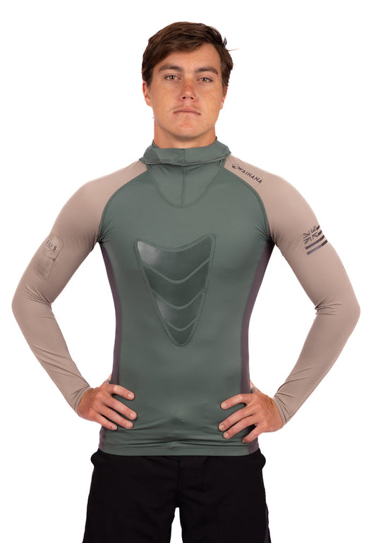 Male model wearing the Waihana Terra Hooded Spearfishing Rashguard in olive green and sand tan colorway, featuring a chest loading pad, mock neck hood, and Hawaiian flag sleeve logo.