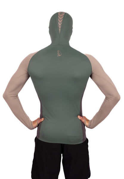 Back view of a man wearing the Waihana Terra Hooded Spearfishing Rashguard in a two-tone olive green and tan colorway with chevron branding on the hood, against a white background.