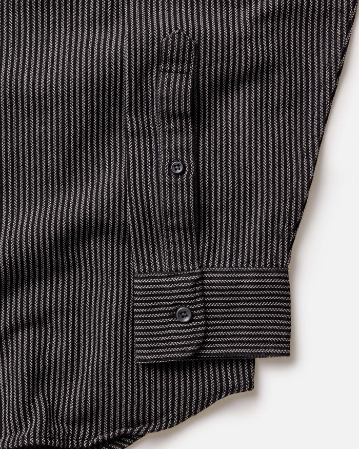 Close-up detail of The Jack in Roped Black Indigo showing roped indigo stripe fabric texture, button placket, and barrel cuff