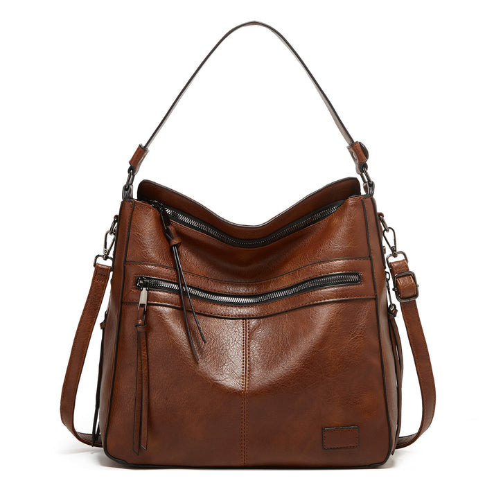tote bag on desk next to laptop and coffee, commuter shoulder bag with zipper top and quiet luxury vibe