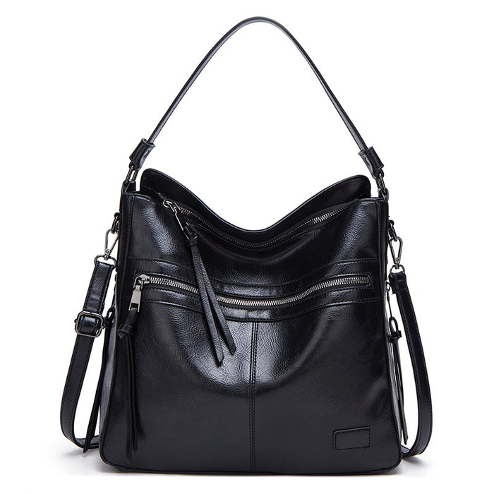 tote bag worn crossbody on coat outfit, PU handbags for women style with secure zip and roomy silhouette