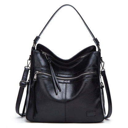 tote bag worn crossbody on coat outfit, PU handbags for women style with secure zip and roomy silhouette